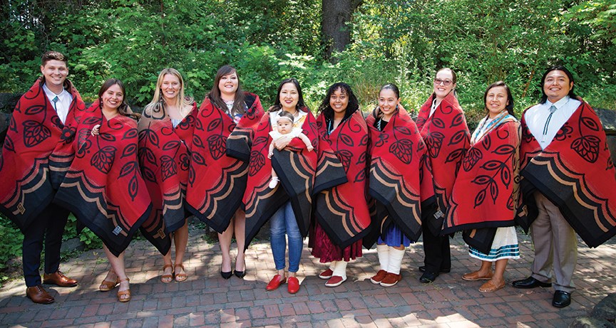 (Left to right) Wy’east Post Baccalaureate Pathway students, following a blanket ceremony on June 14, 2019 at PSUÕs Native American Student Community Center: Jacob Smith, Audrey Juliussen, Kayla Murphy, Kyna Lewis, Jessica Souphanavong and her daughter, Matilda, Jasmine Curry, Ashley Wirth, Baroness ÒBÓ Castra Nemici, Candice Jimenez, and Aaron Thomas. The Wy’east program provides conditional acceptance into the OHSU medical school, for students who complete the pathway. (OHSU/Michael Schmitt)